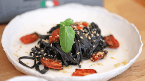Linguine di Campofilone al Nero di Seppia con filetti di alici, pomodorini confit e granella di nocciola